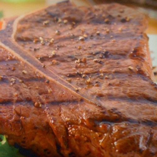 A grilled steak, peppered and seared.